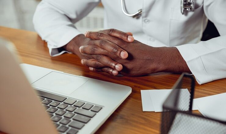 africanamerican-doctor-consulting-patient-working-cabinet-close-up_155003-40748